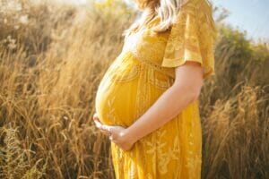 pregnant woman in a yellow dress