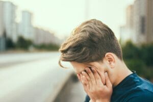 a tired boy in the street