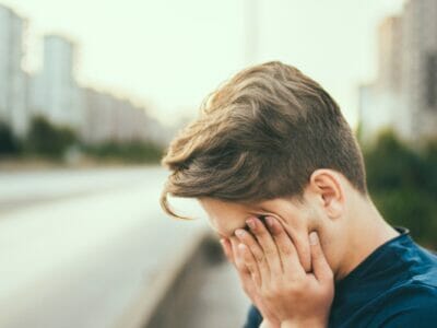 a tired boy in the street