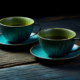 two tea cups on a wooden table