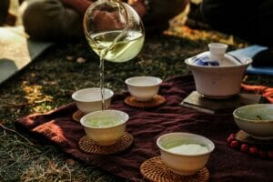 green tea in pottery and glasses 