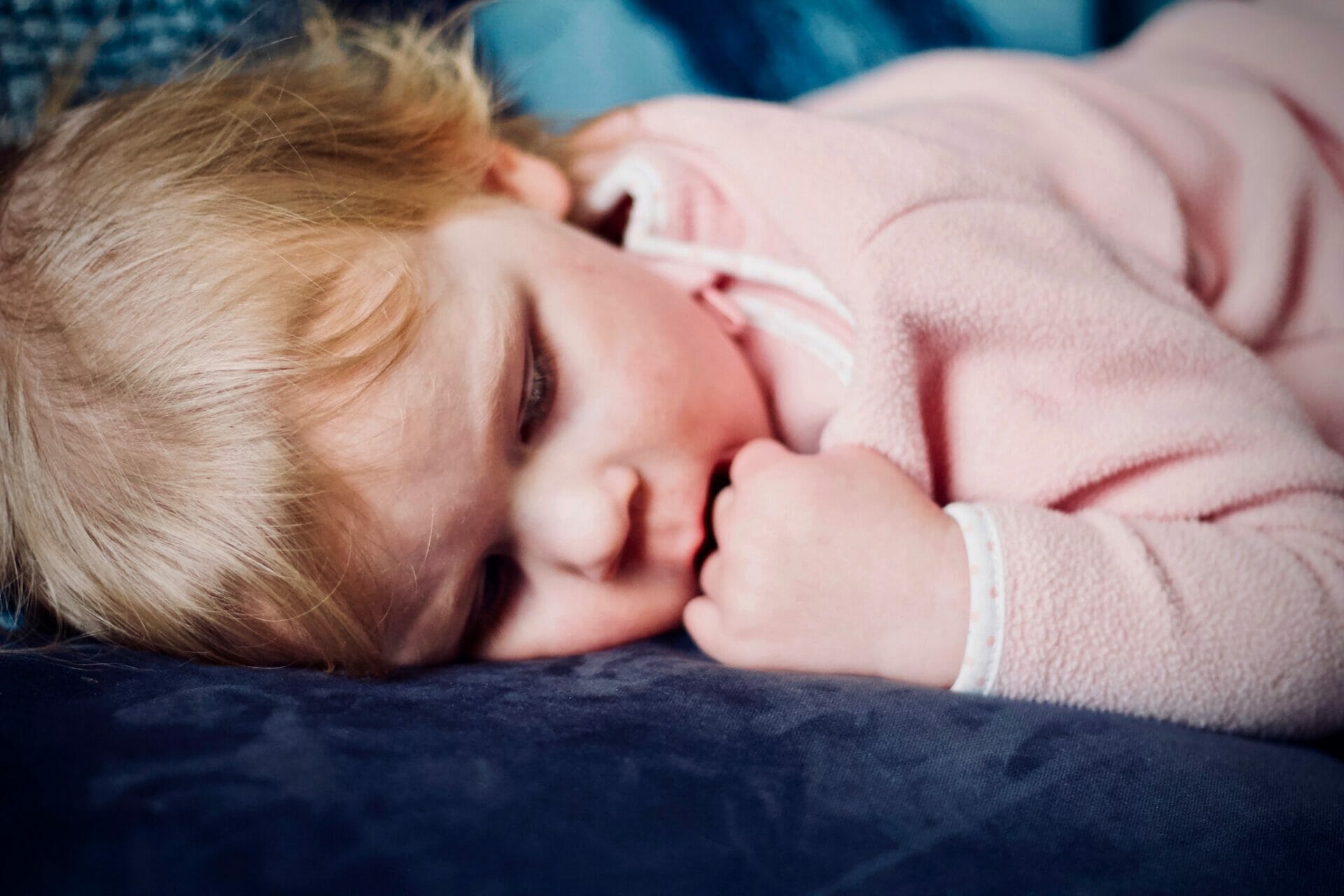 sleeping baby girl wearing pink 